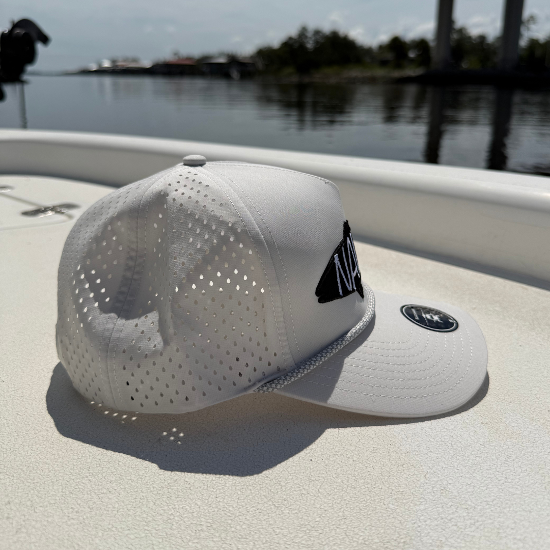 Side view of the Backwater Snapback hat on a boat