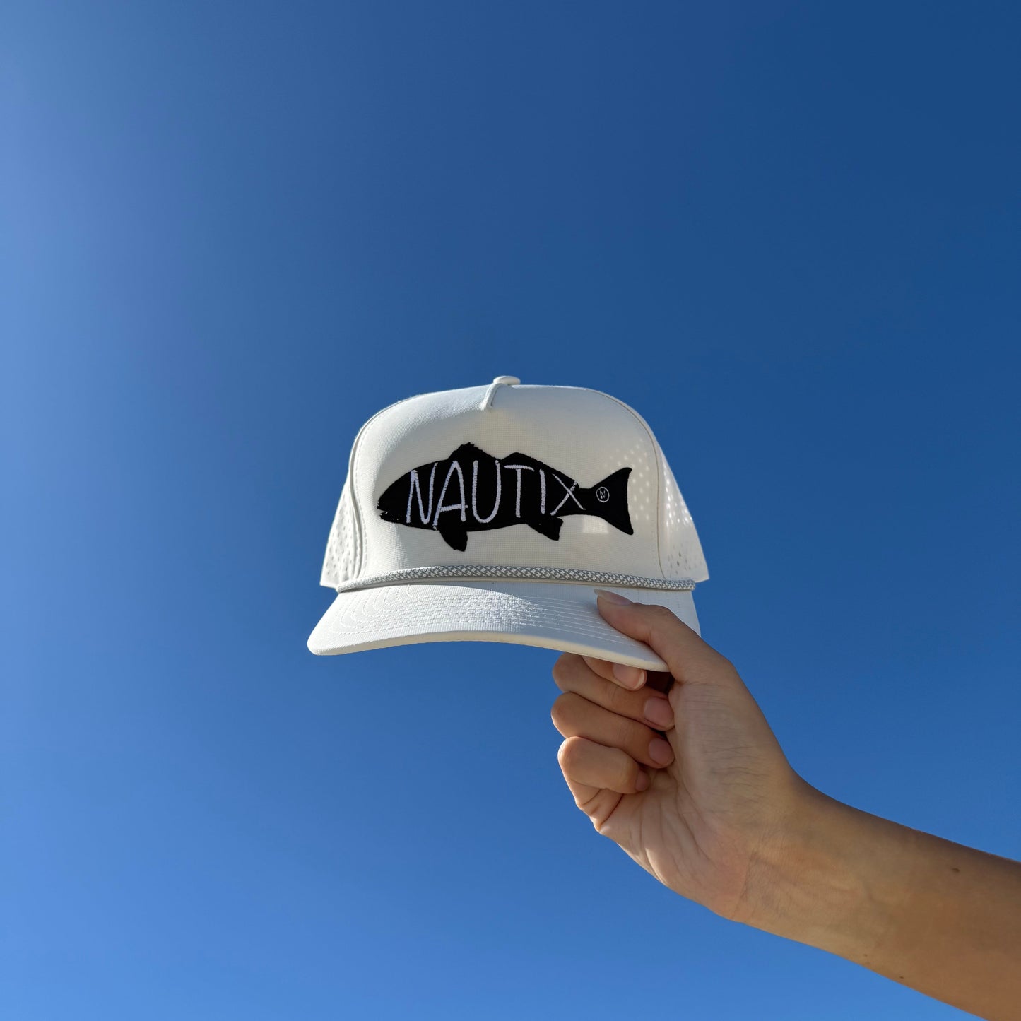 Lifestyle image of Backwater Snapback hat in sky.