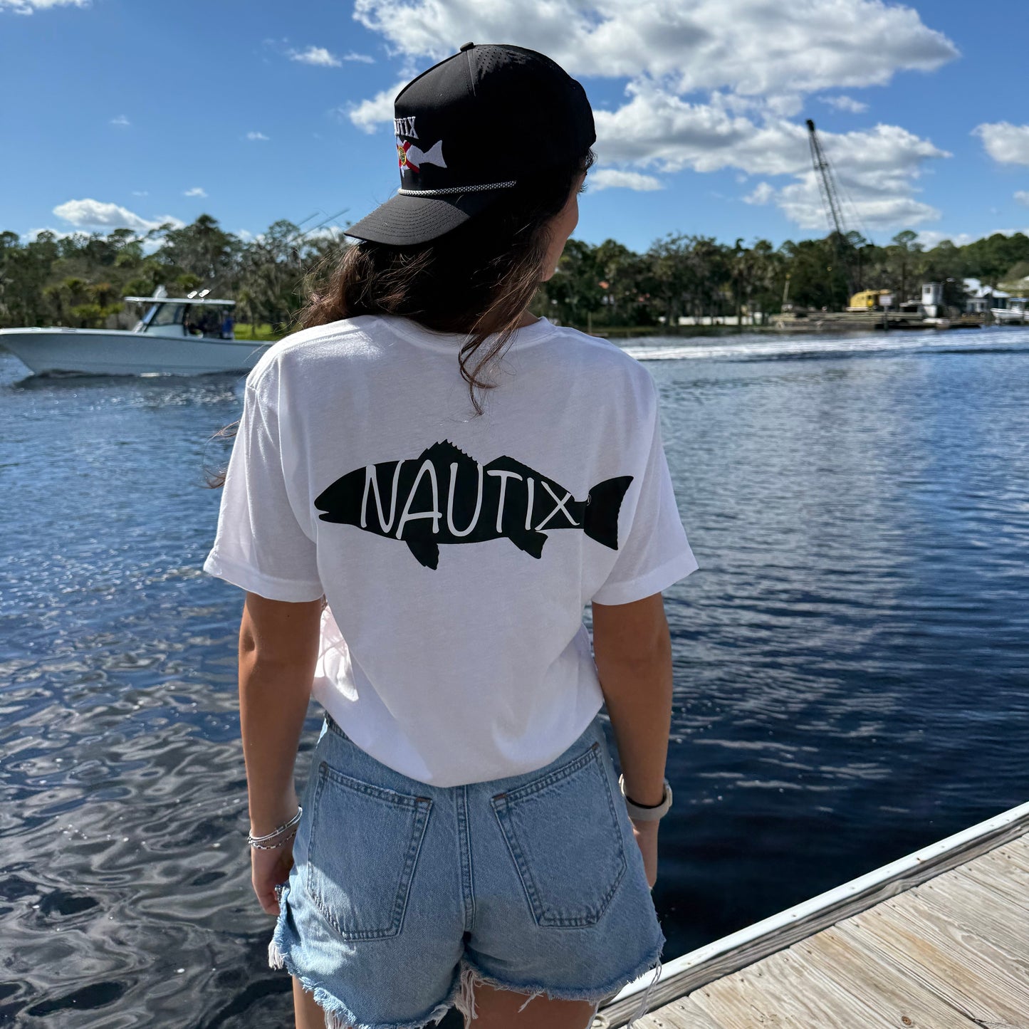 Woman wearing Backwater Tee on the water 