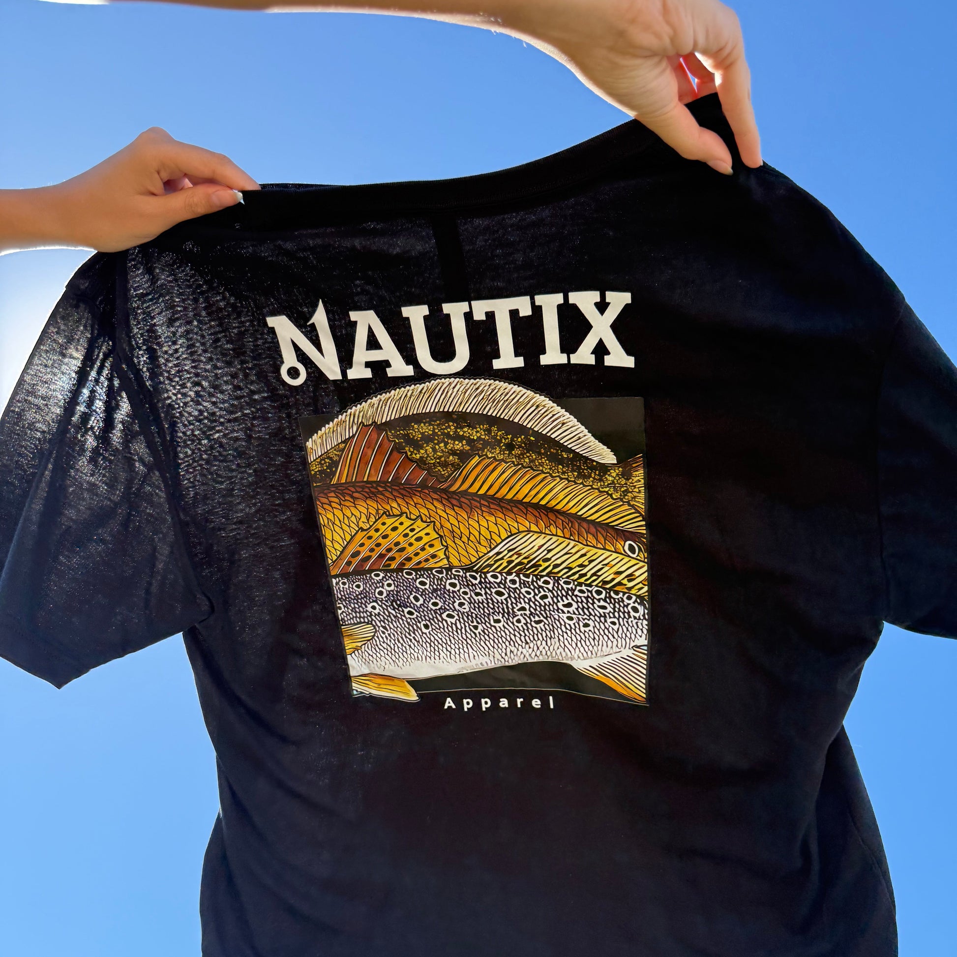 Person holding slam art tee in black in the sky 