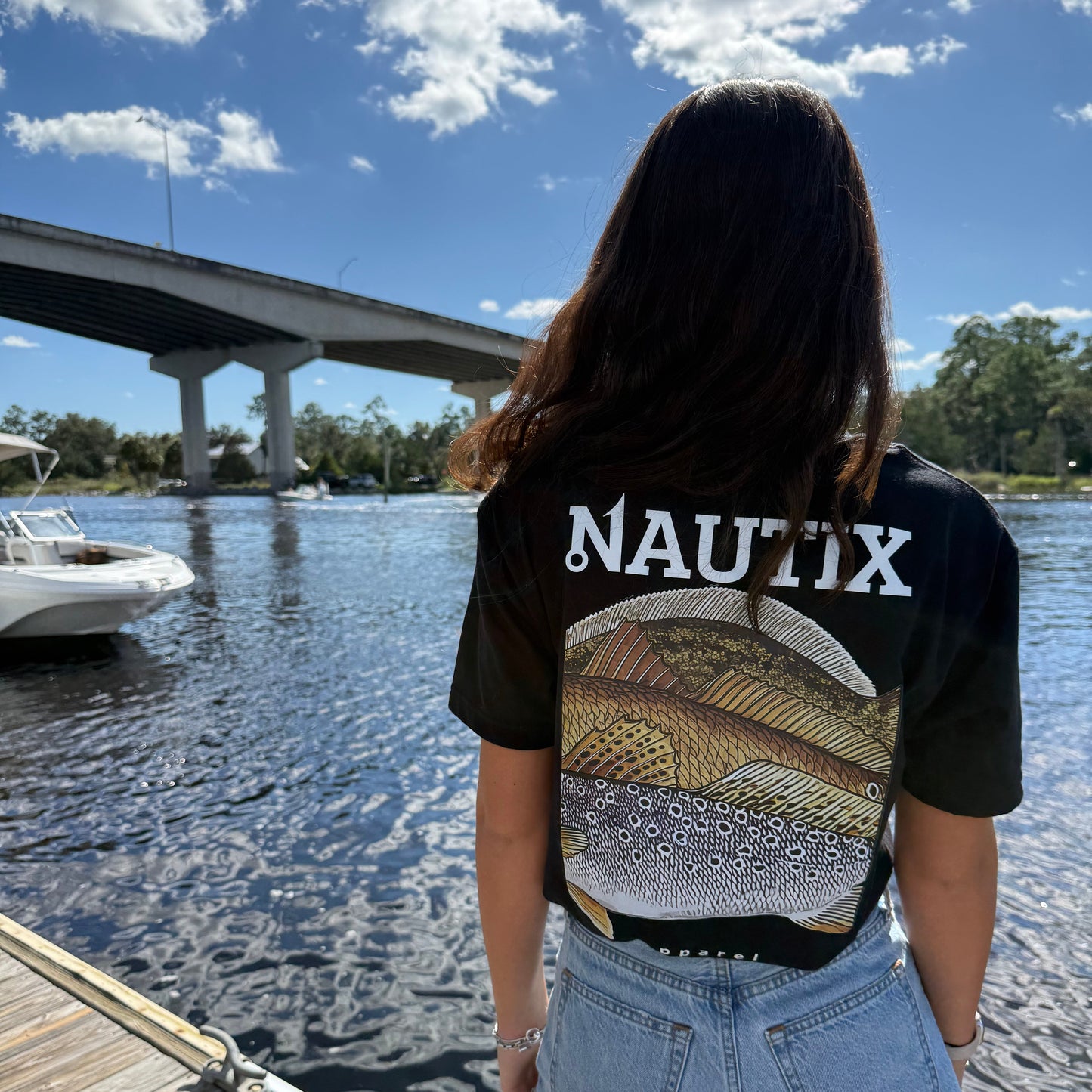 Model wearing black Slam Art tee with large slam fish graphic on back